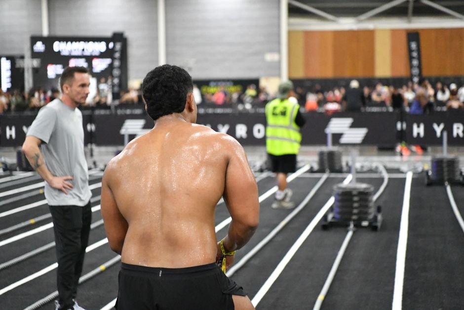 HYROX competition sled push athlete exhaustion